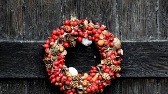 Ghirlanda natalizia appesa alla porta &copy; Pexels