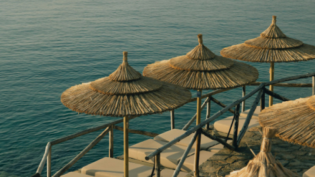 Ombrelloni di paglia vicino al mare &copy; Pexels.