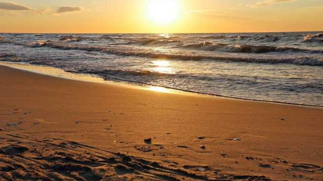 Spiaggia e mare al tramonto &copy; Pixabay.